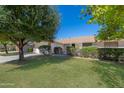 House exterior showcasing a large front yard and mature landscaping at 9614 W Greenhurst Dr, Sun City, AZ 85351