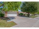 Brick ranch home with attached garage and well-manicured lawn at 9614 W Greenhurst Dr, Sun City, AZ 85351