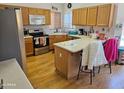 Kitchen with wood cabinets, island, and stainless steel appliances at 16549 N 91St Dr, Peoria, AZ 85382