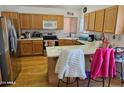 Kitchen with wood cabinets, island, and stainless steel appliances at 16549 N 91St Dr, Peoria, AZ 85382