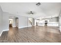 Open-concept living area with wood-look floors and views into the kitchen at 654 S Sabrina --, Mesa, AZ 85208