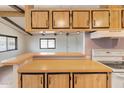 Kitchen features wood cabinets, a built-in range, and a breakfast bar at 3330 E Main St # 440, Mesa, AZ 85213