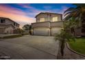 Two-story house with a three-car garage and desert landscaping at 21723 N 67Th Dr, Glendale, AZ 85308