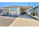 Inviting manufactured home exterior with covered carport and nicely landscaped front at 305 S Val Vista Drive -- # 291, Mesa, AZ 85204