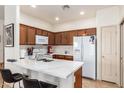 Modern kitchen with white quartz countertops and wood cabinetry at 1560 E Melrose Dr, Casa Grande, AZ 85122