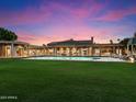 Expansive backyard oasis featuring a large pool and lush green lawn at 40 Biltmore Est, Phoenix, AZ 85016