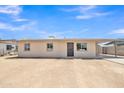 Ranch-style home with a light beige exterior and a spacious yard at 1325 W Lily Pl, Casa Grande, AZ 85122