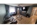 Living room with comfy seating and large TV at 5753 N 31St Ln, Phoenix, AZ 85017
