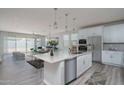 Modern kitchen with white cabinets and a large island at 16172 W Alameda Rd, Surprise, AZ 85387