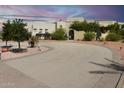 Long curved driveway leading to a three-car garage at 19950 W Cambridge Ave, Buckeye, AZ 85396