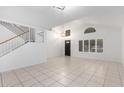Bright and airy living room with tile floors and a staircase at 2605 N 89Th Dr, Phoenix, AZ 85037