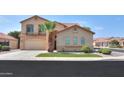 Two-story house with tan exterior and a three-car garage at 1121 E Jahns Dr, Casa Grande, AZ 85122