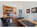 Home office with built-in shelving and desk at 7514 E Oasis Cir, Mesa, AZ 85207