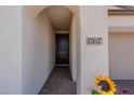 Front entry with an arched walkway and dark brown door at 1767 W Hopi Dr, Coolidge, AZ 85128