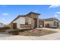 Modern home with stone and stucco exterior, two-car garage and landscaping at 7245 S 75Th Dr, Laveen, AZ 85339
