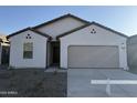 One-story home with a two-car garage and desert landscaping at 13213 E Larrea Ln, Florence, AZ 85132