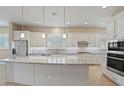 Modern kitchen featuring granite island, white cabinets, and stainless steel appliances at 25807 N 19Th Gln, Phoenix, AZ 85085