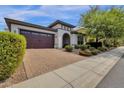 House exterior with a two-car garage and manicured landscaping at 2126 W Red Fox Rd, Phoenix, AZ 85085