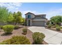 Two-story home with gray exterior, landscaping, and a two-car garage at 8933 W Townley Ave, Peoria, AZ 85345