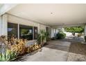 Covered patio with plants and access to the backyard at 18256 N 75Th Ave, Glendale, AZ 85308