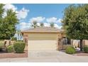 Single-story home with a two-car garage, landscaping, and a neutral color palette at 4920 N 126Th Dr, Litchfield Park, AZ 85340