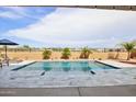 Inviting backyard pool with gray tile deck and mountain views at 15175 S 185Th Ave, Goodyear, AZ 85338