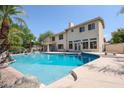 Inviting freeform pool with a diving board and large patio at 19422 N 67Th Ln, Glendale, AZ 85308