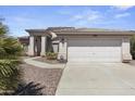 Exterior view of a house with a two-car garage and walkway at 13164 W Ocotillo Ln, Surprise, AZ 85374