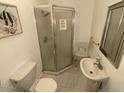 Small bathroom with shower, toilet and pedestal sink at 1517 W Sahuaro Dr, Phoenix, AZ 85029