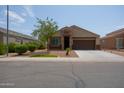 Charming curb appeal with landscaping and driveway at 2040 N Ensenada Ln, Casa Grande, AZ 85122