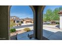 View of neighborhood homes and mountains from covered entryway at 7351 W Palo Brea Ln, Peoria, AZ 85383