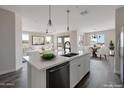 Modern kitchen with island, stainless steel appliances, and dining area at 3820 N Juniper Dr, Eloy, AZ 85131