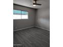 Spacious bedroom with ceiling fan and gray tile floors at 810 E Colter St # 22, Phoenix, AZ 85014