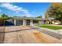 Mid-century modern home with artificial turf and updated landscaping at 1236 E Mclellan Blvd, Phoenix, AZ 85014