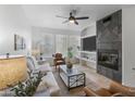 Spacious living room featuring a stone fireplace and comfortable seating at 6900 E Princess Dr # 2221, Phoenix, AZ 85054