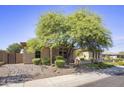 Single-story home with stone accents and a landscaped front yard at 3051 W Sousa Ct, Anthem, AZ 85086