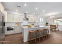 Modern kitchen with white cabinets and island seating at 25226 N 131St Dr, Peoria, AZ 85383