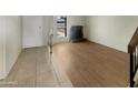Living room with tile and wood-look floors, and a fireplace at 2617 W Willow Ave, Phoenix, AZ 85029