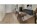 Living room with fireplace, staged furniture, and wood-look floors at 2617 W Willow Ave, Phoenix, AZ 85029