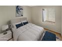 Bright bedroom with a queen-size bed and access to a patio at 2617 W Willow Ave, Phoenix, AZ 85029