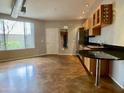 Modern kitchen with wood cabinets, stainless steel appliances, and granite countertop at 1701 E Colter St # 141, Phoenix, AZ 85016