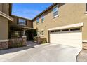 Front entrance and garage with stone accents and lush landscaping at 2755 E Palmer St, Gilbert, AZ 85298