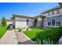 Single-story home with landscaped front yard, paver walkway, and artificial turf at 10611 E Tumbleweed Ave, Mesa, AZ 85212