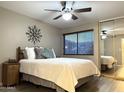 Bright bedroom with ceiling fan and mirrored closet at 1111 E University Dr # 135, Tempe, AZ 85288