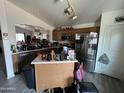 Kitchen features an island and stainless steel appliances at 22005 W Cocopah St, Buckeye, AZ 85326