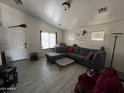 Spacious living room with L-shaped sofa and tile flooring at 22005 W Cocopah St, Buckeye, AZ 85326
