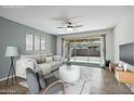 Virtually staged living room with sofa and large window at 2471 E Stacey Rd, Gilbert, AZ 85298