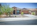 Single story home with a two car garage at 10773 W Swayback W Pass, Peoria, AZ 85383
