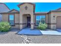 Tan house with a landscaped front yard and a rock pathway at 10773 W Swayback W Pass, Peoria, AZ 85383