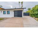 Modern garage with updated door and concrete driveway at 8608 E Angus Dr, Scottsdale, AZ 85251